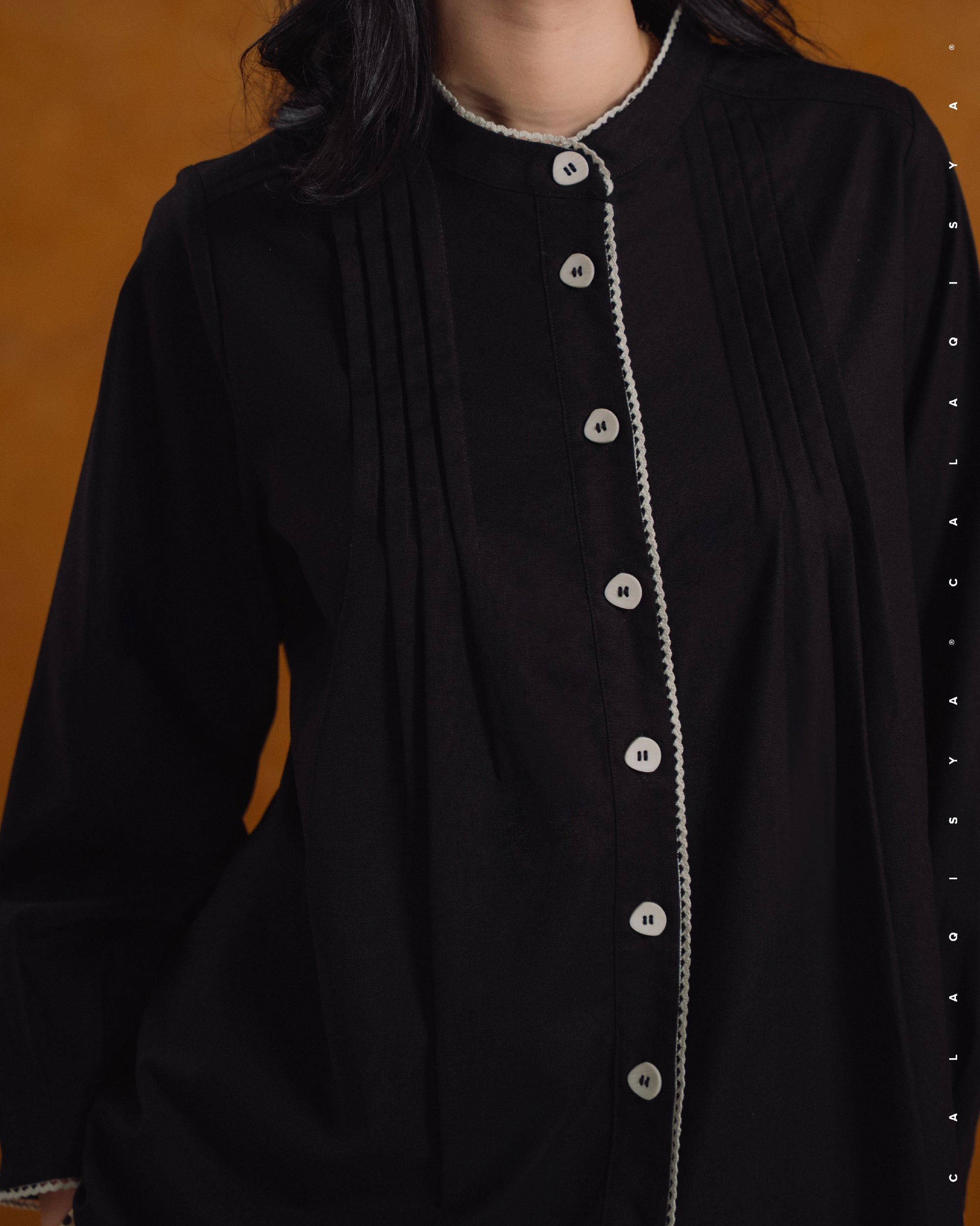 MORA PINTUCK TOP IN BLACK